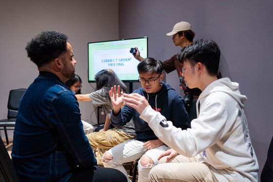 Delegates experiencing how youths pray during a connect group meeting in Heart of God Church Singapore